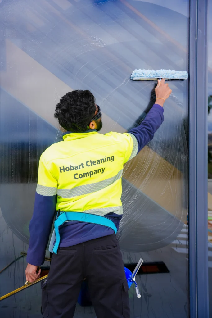 A Hobart Cleaning Company professional providing exterior window washing and glass cleaning services for a commercial building in Hobart.